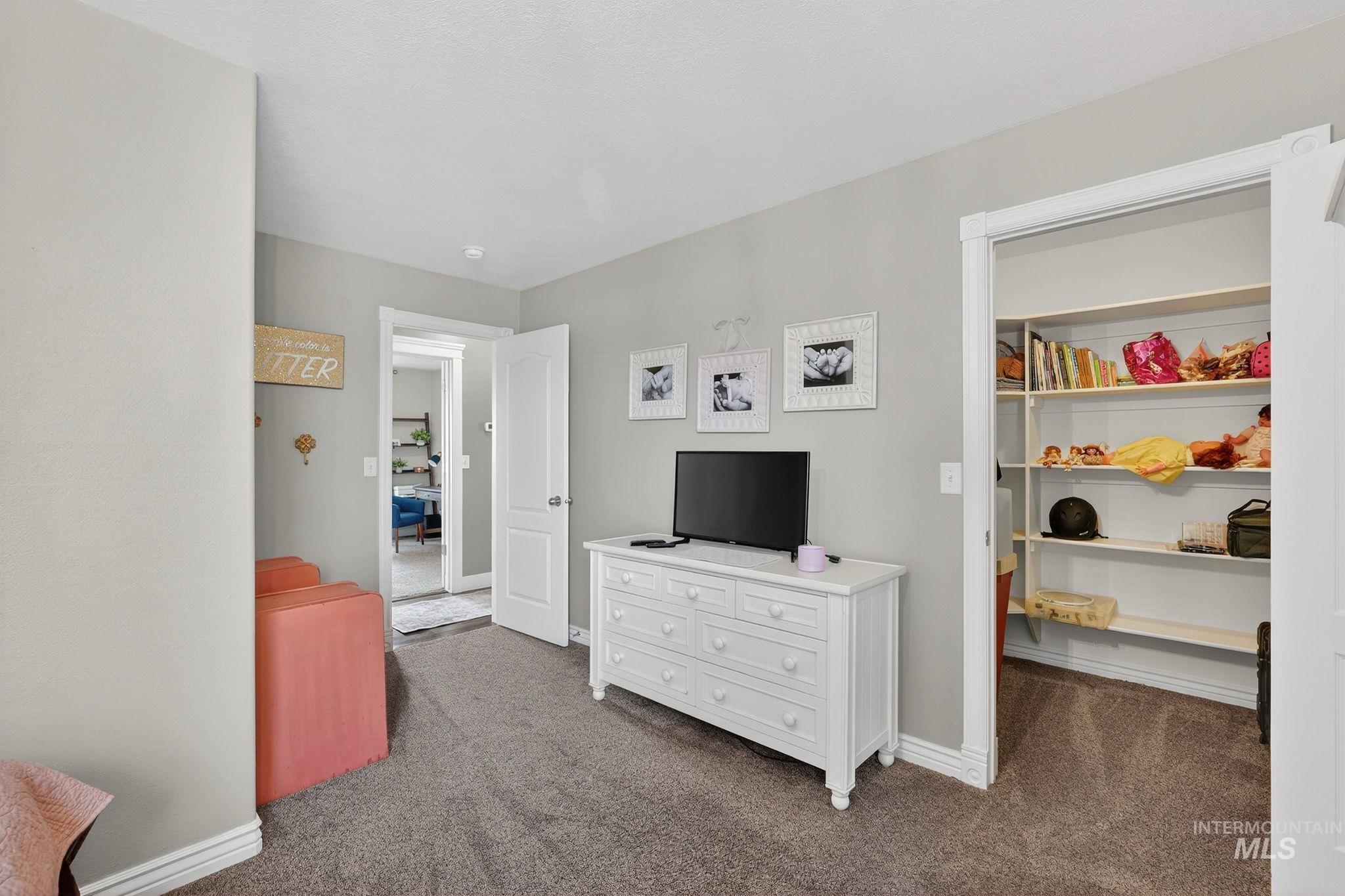880 Redman Street Chubbuck, ID 83202 - Photo 20 of 39 Bedroom with dark colored carpet and baseboards