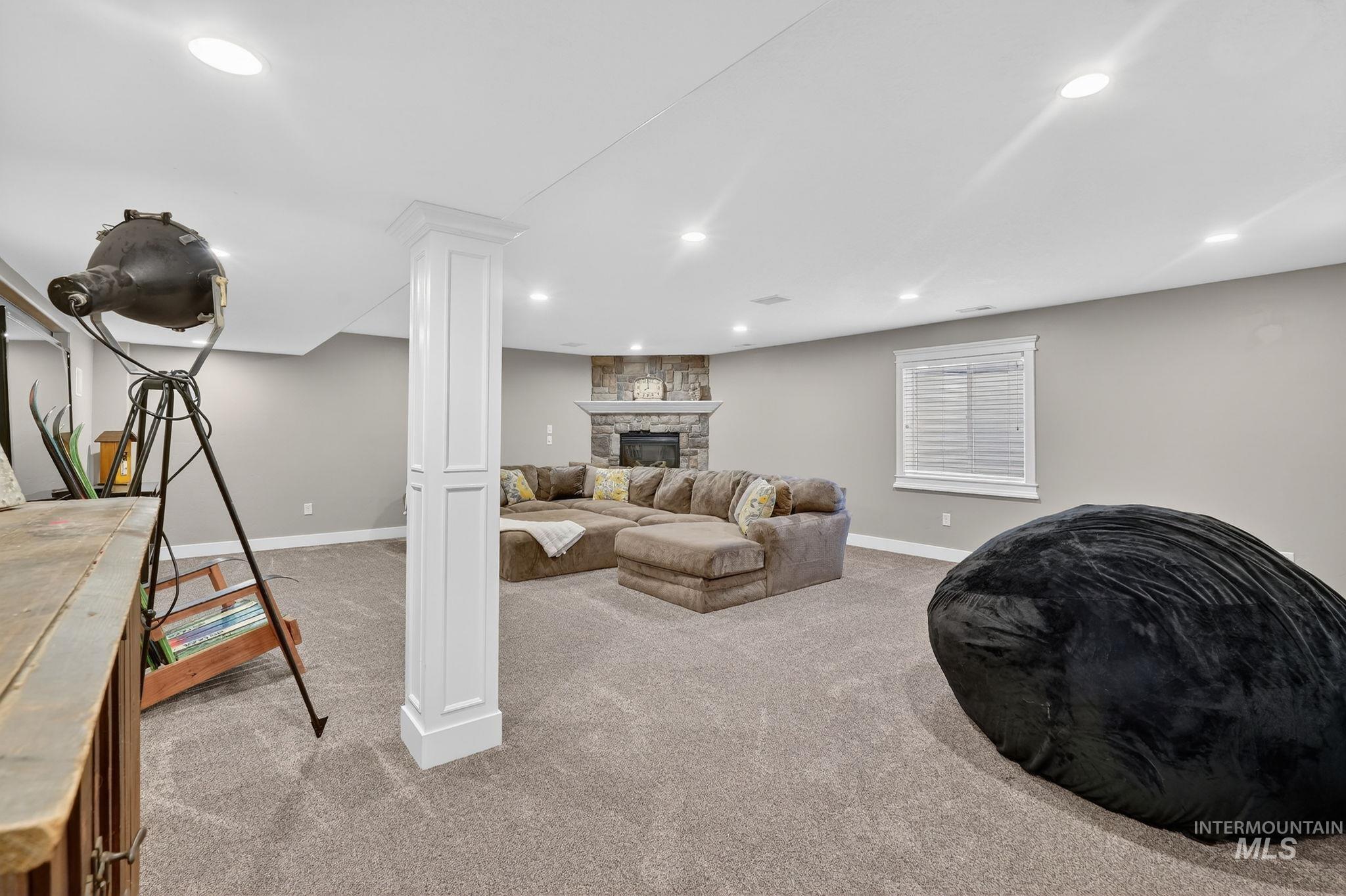 880 Redman Street Chubbuck, ID 83202 - Photo 22 of 39 Living area with light colored carpet, a fireplace, and recessed lighting