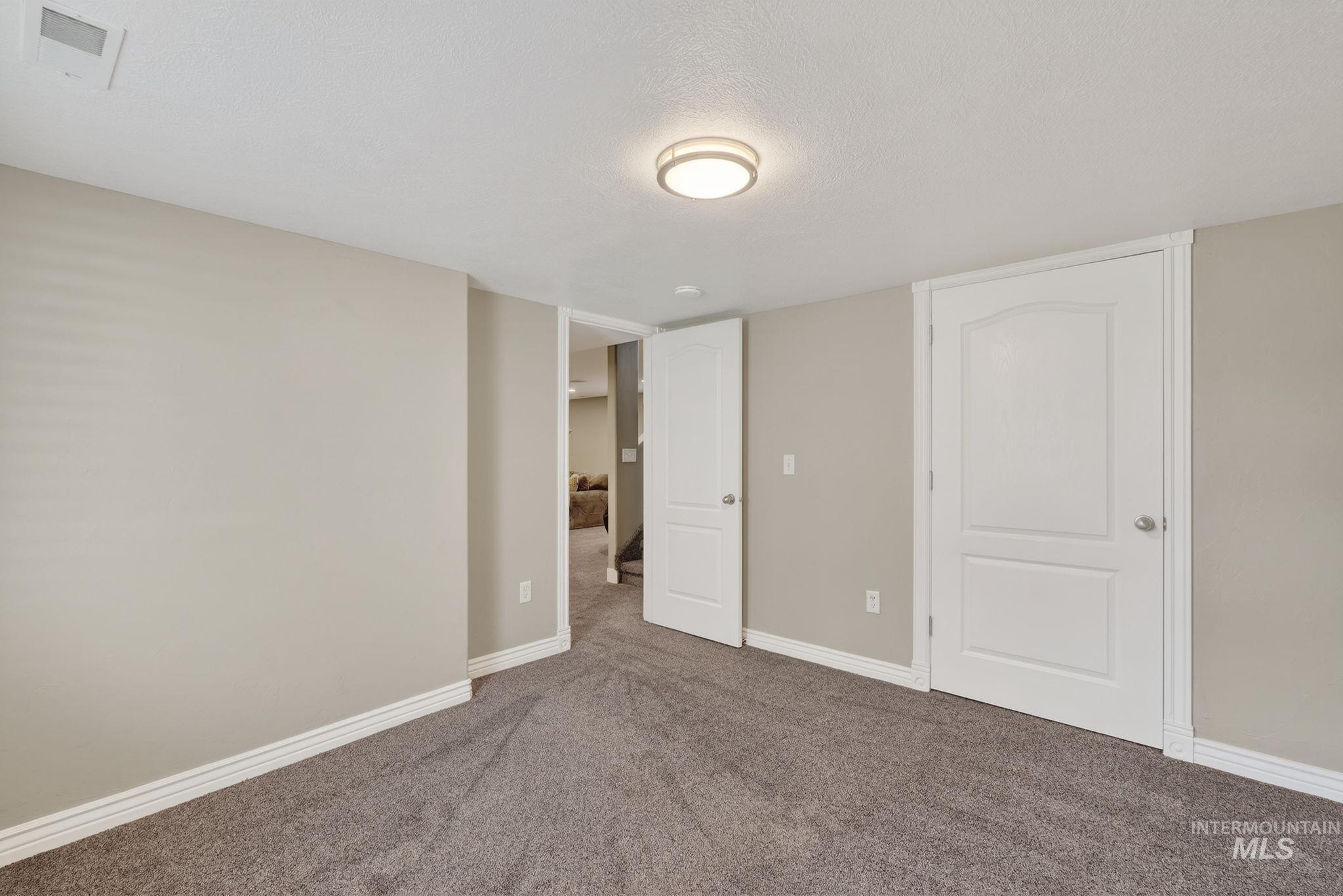 880 Redman Street Chubbuck, ID 83202 - Photo 26 of 39 Unfurnished bedroom with carpet and a textured ceiling