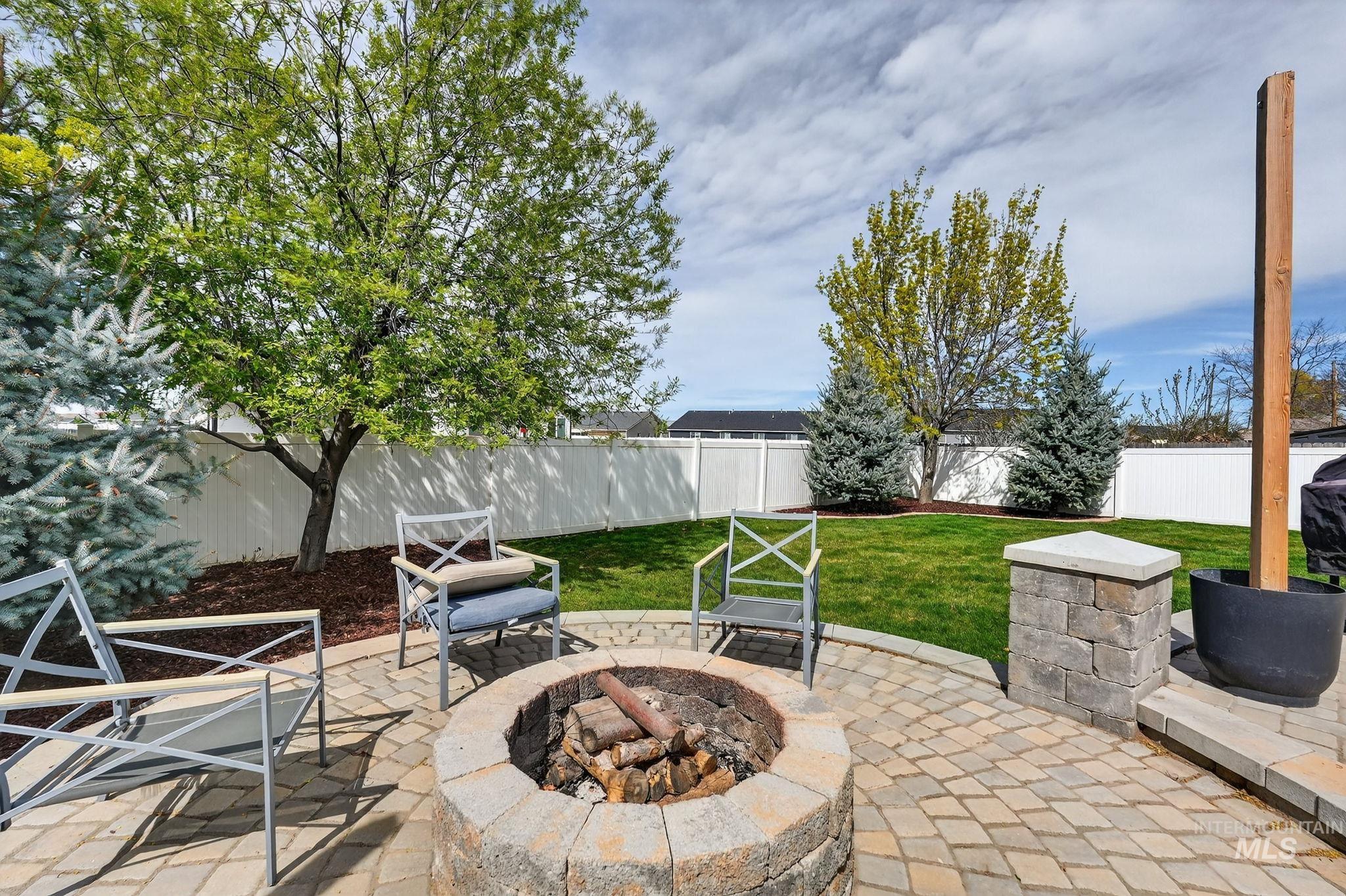 880 Redman Street Chubbuck, ID 83202 - Photo 28 of 39 Fenced backyard with a patio and an outdoor fire pit