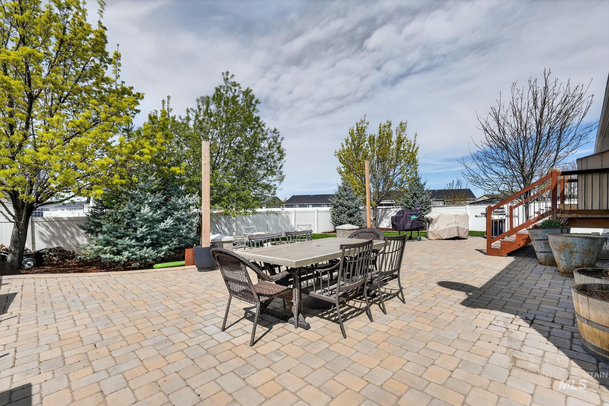 880 Redman Street Chubbuck, ID 83202 - Photo 31 of 39 Fenced backyard with a patio area, outdoor dining space, and a playground
