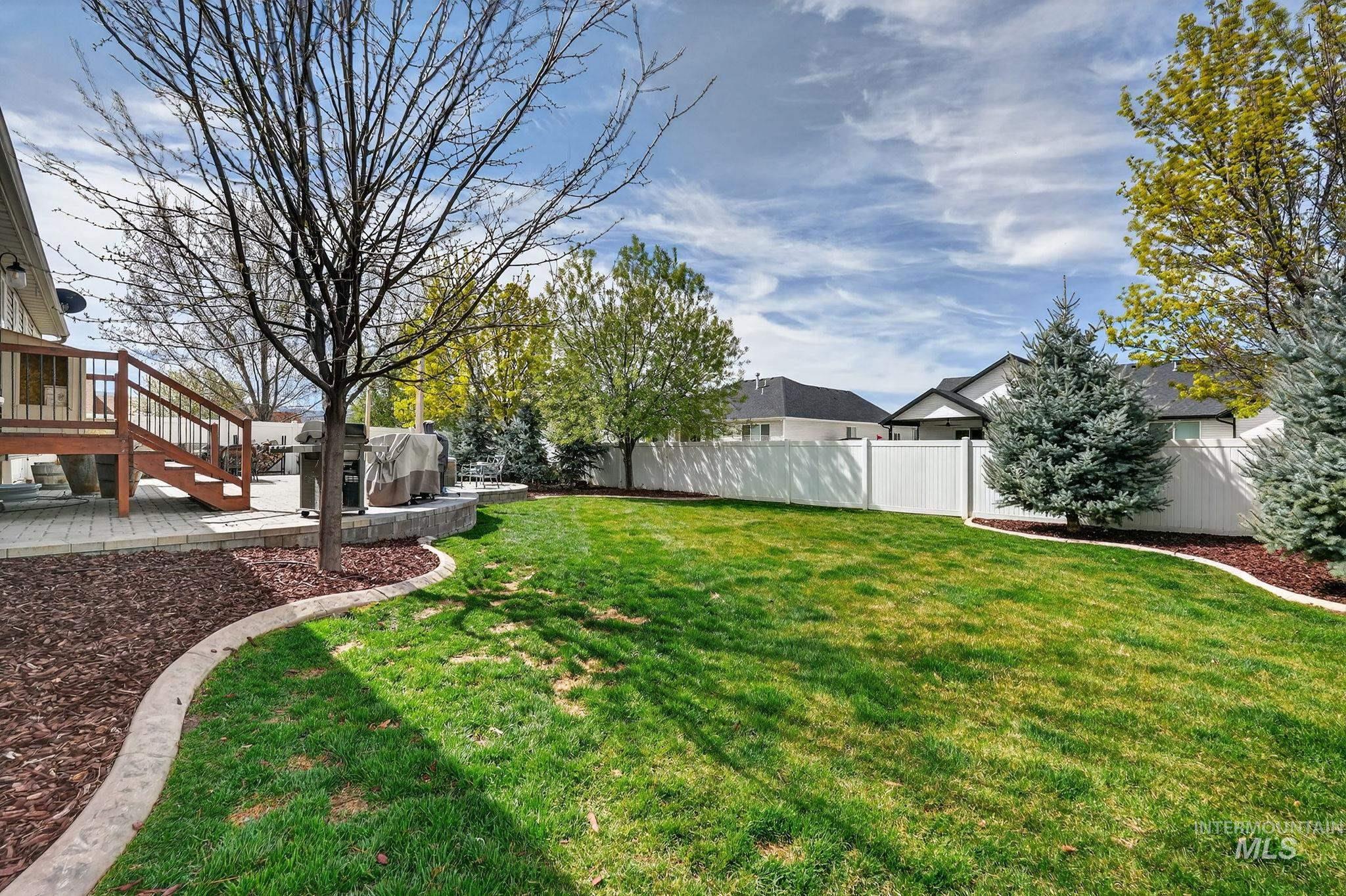 880 Redman Street Chubbuck, ID 83202 - Photo 32 of 39 Fenced backyard featuring a wooden deck and stairs