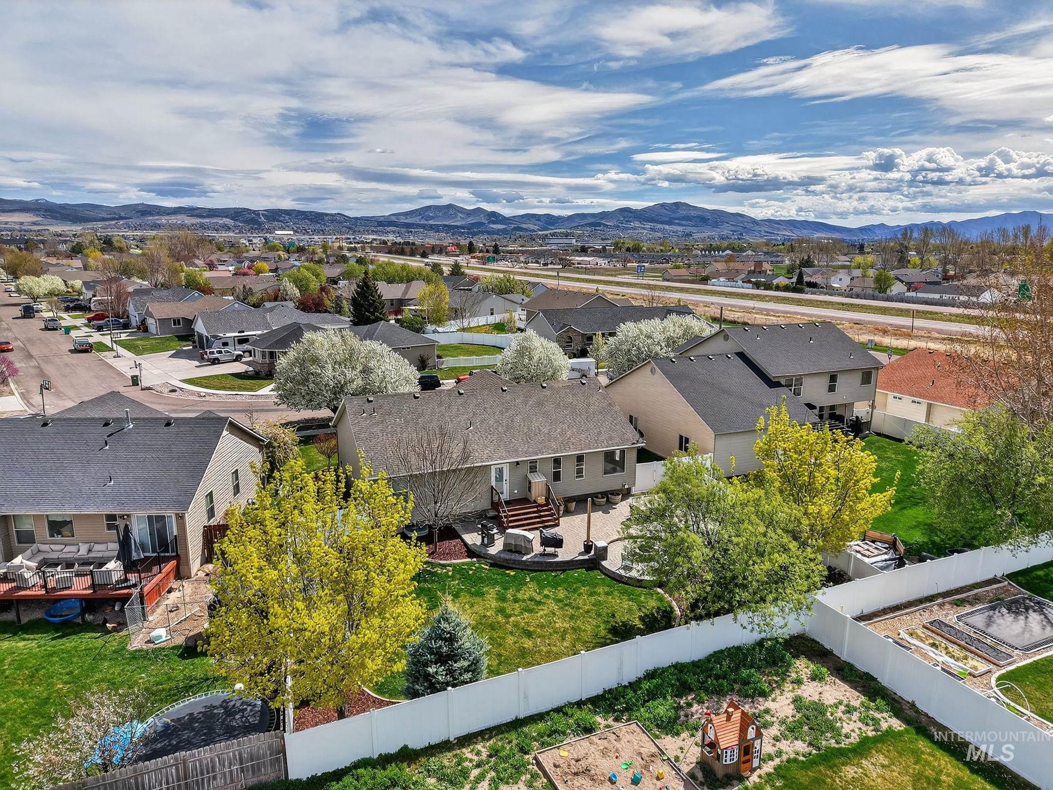 880 Redman Street Chubbuck, ID 83202 - Photo 37 of 39 Aerial perspective of suburban area featuring a mountain backdrop