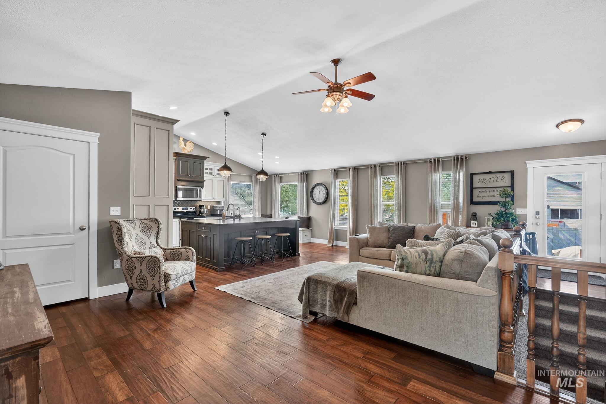 880 Redman Street Chubbuck, ID 83202 - Photo 6 of 39 Living room with dark wood-style floors, lofted ceiling, a ceiling fan, and recessed lighting