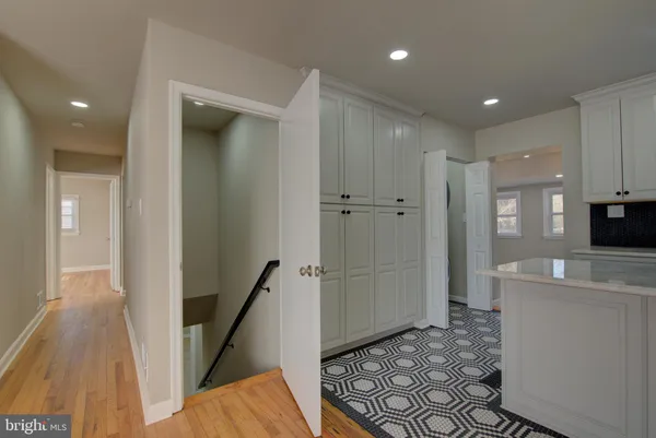 a view of a hallway with wooden floor and staircase
