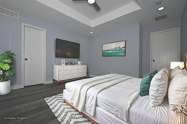 a bedroom with a bed and a television