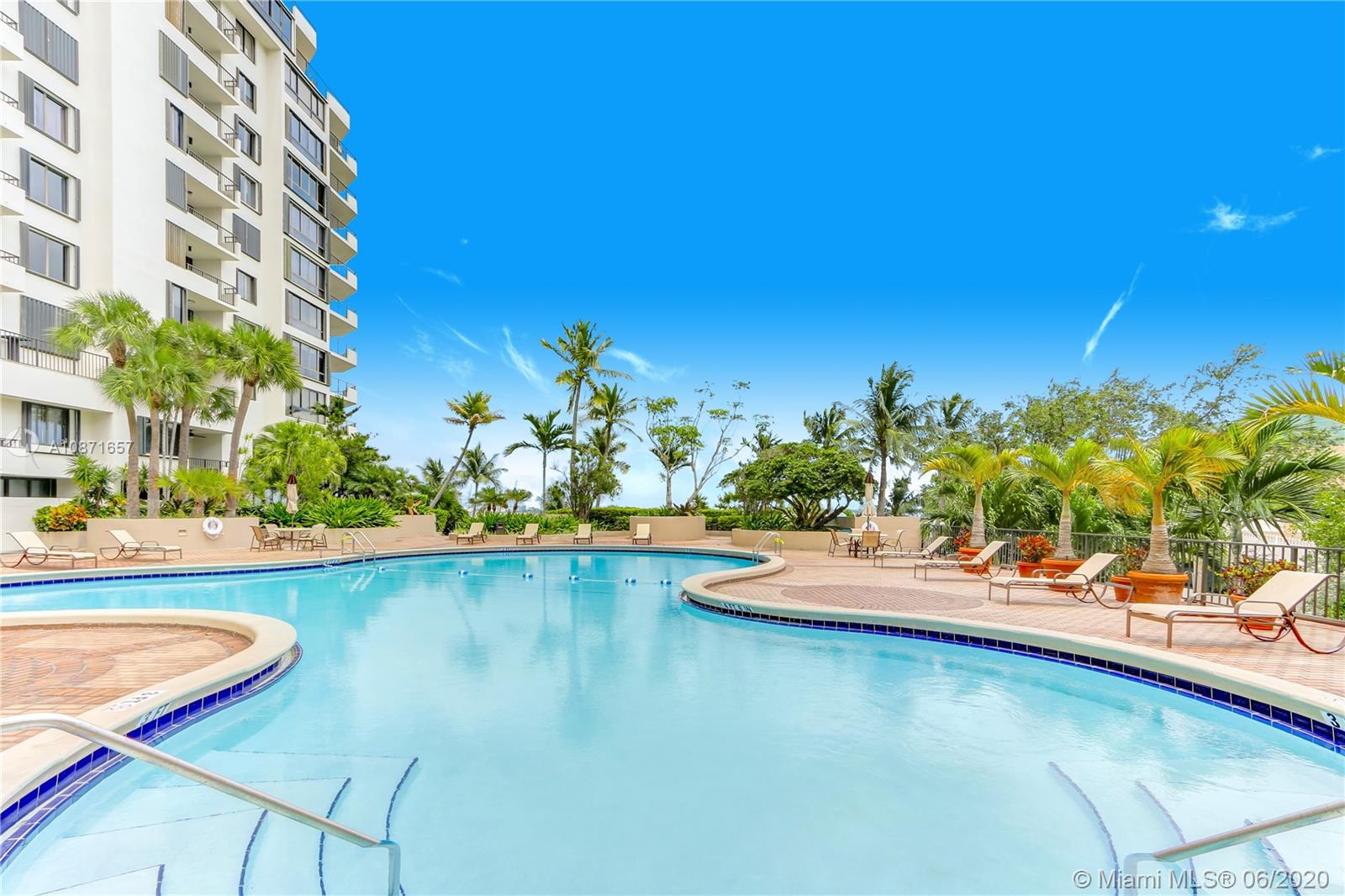 520 Brickell Key Drive, Unit A1702 Miami, FL 33131 - Photo 12 of 13 a view of a swimming pool with a lounge chair