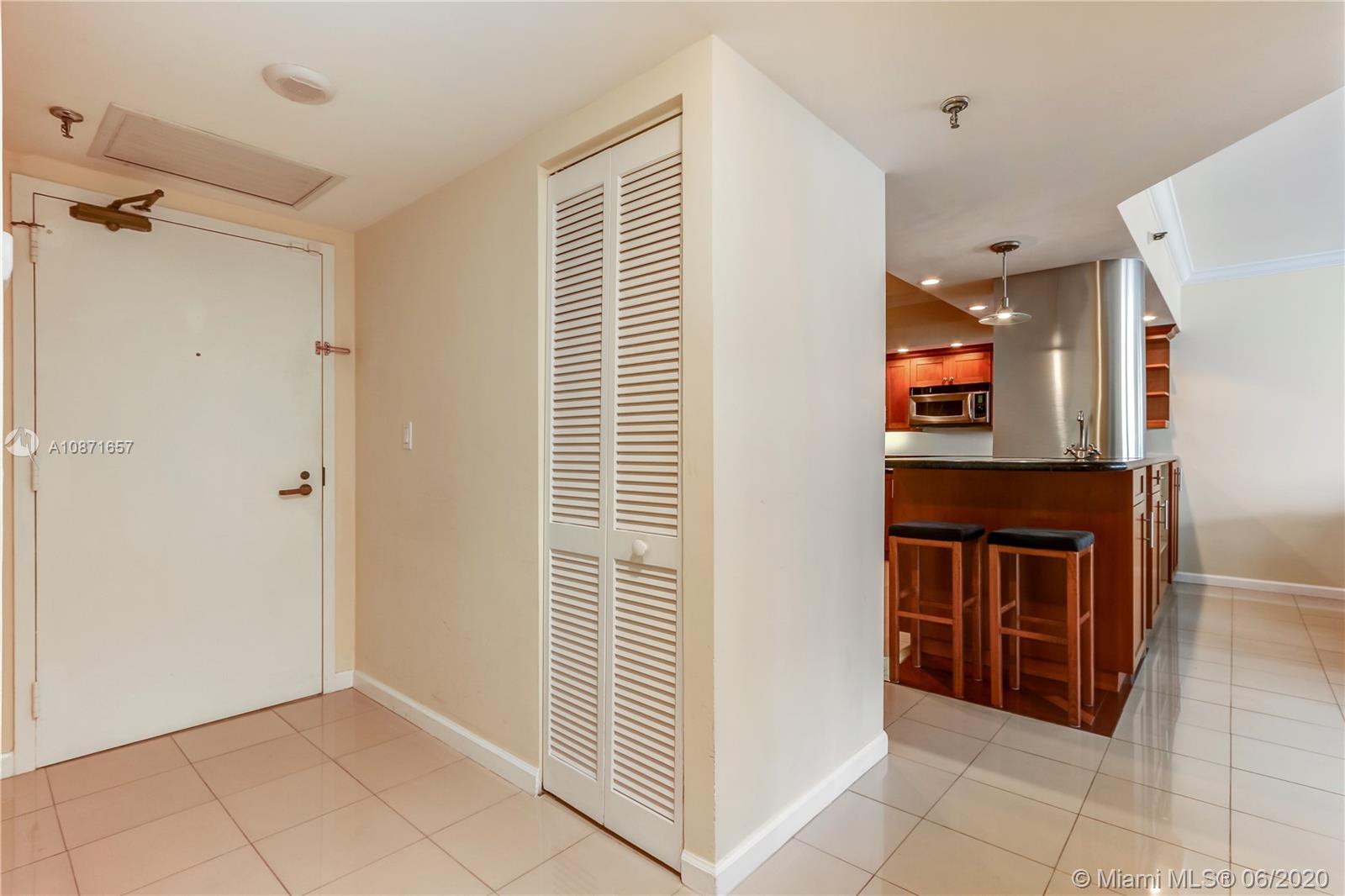 520 Brickell Key Drive, Unit A1702 Miami, FL 33131 - Photo 4 of 13 a view of a hallway to rooms and stairs