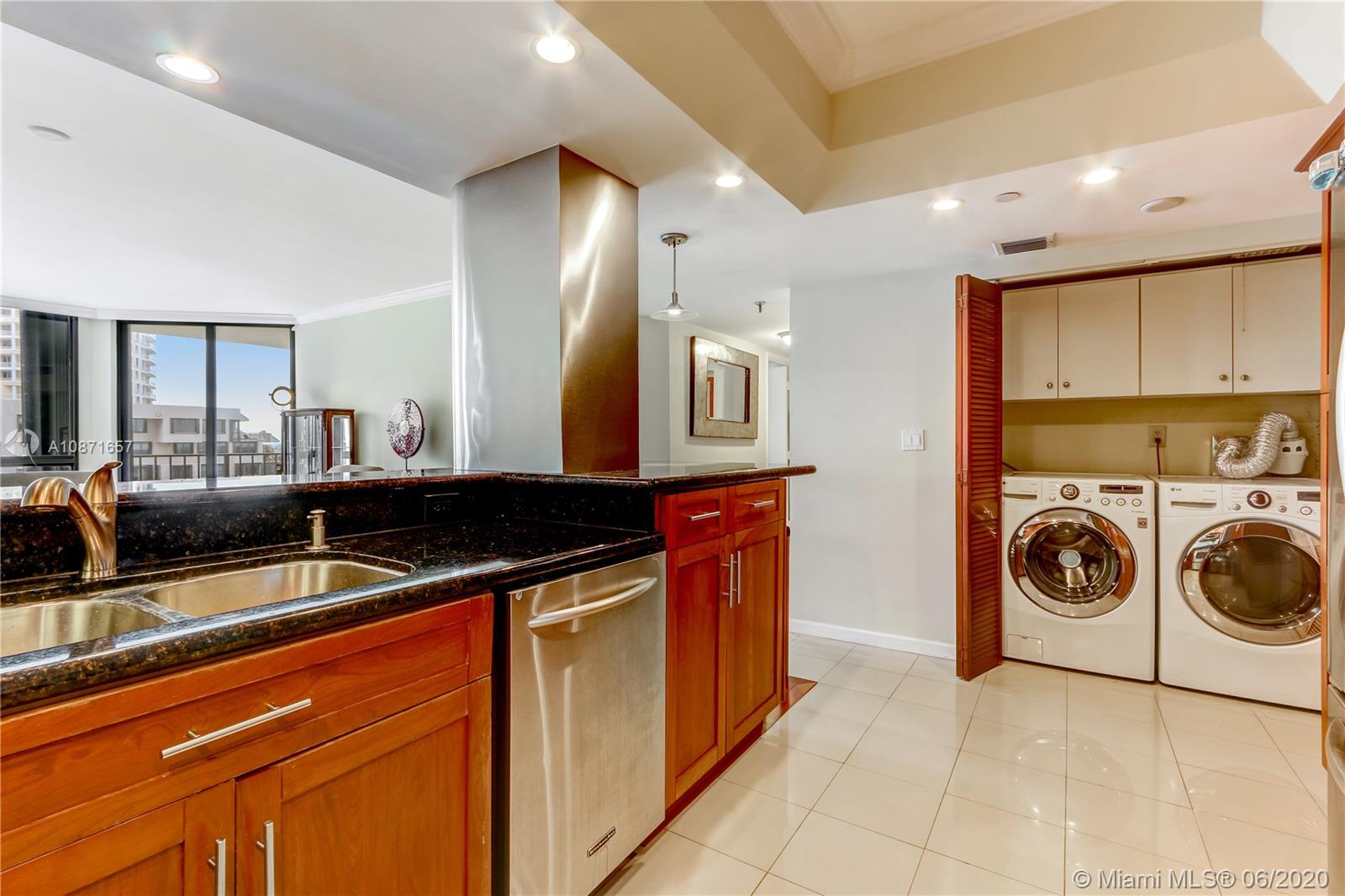 520 Brickell Key Drive, Unit A1702 Miami, FL 33131 - Photo 6 of 13 a view of a kitchen with a sink and a stove top oven