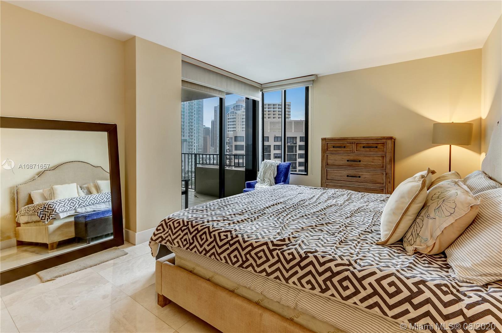 520 Brickell Key Drive, Unit A1702 Miami, FL 33131 - Photo 8 of 13 a bedroom with a bed and walk in closet