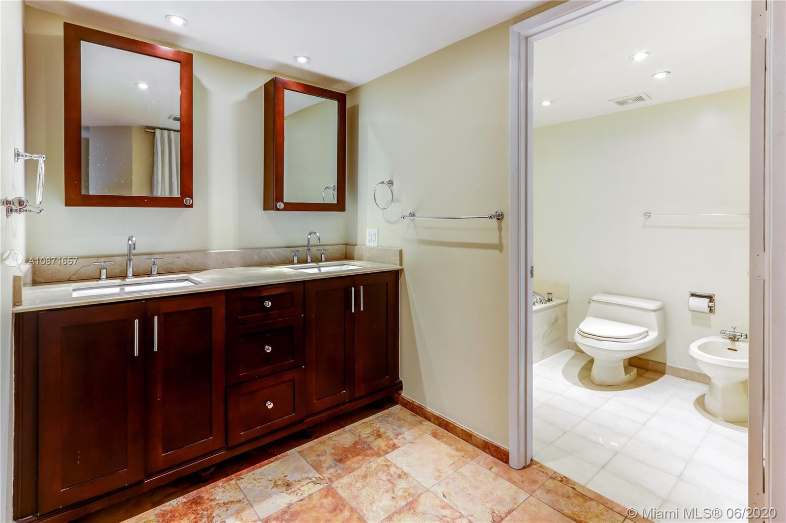 520 Brickell Key Drive, Unit A1702 Miami, FL 33131 - Photo 9 of 13 a bathroom with a sink and a mirror