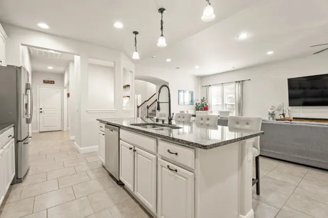 a kitchen with granite countertop a sink and stove