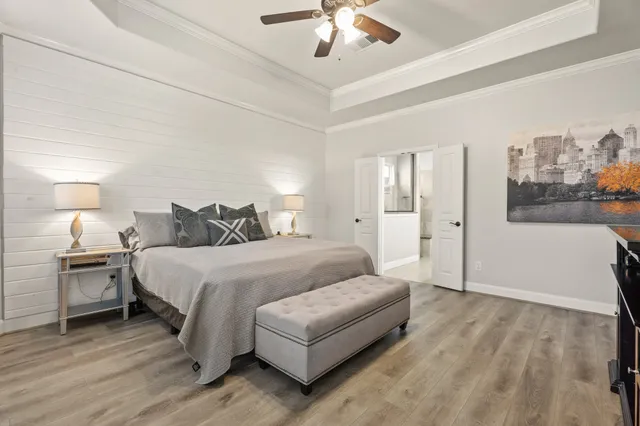 a spacious bedroom with a bed and a chandelier