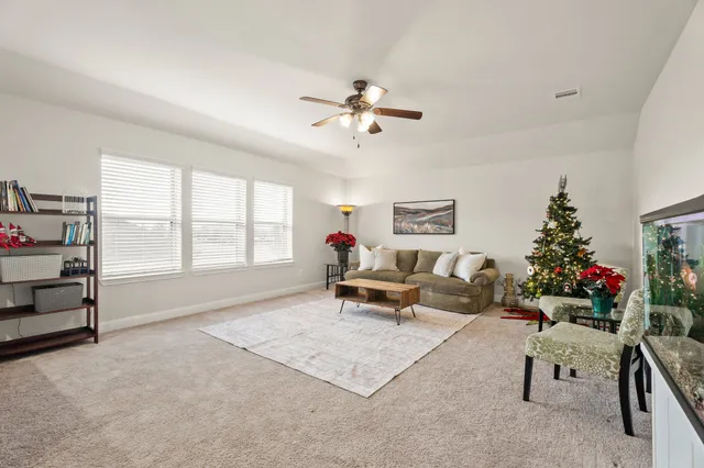 a living room with furniture gym equipment and a large window