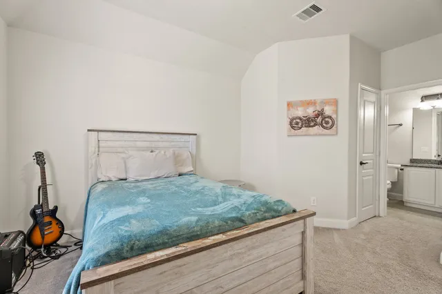 a bedroom with a bed and hallway