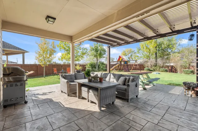 a view of a patio with couches chairs and a table and chairs