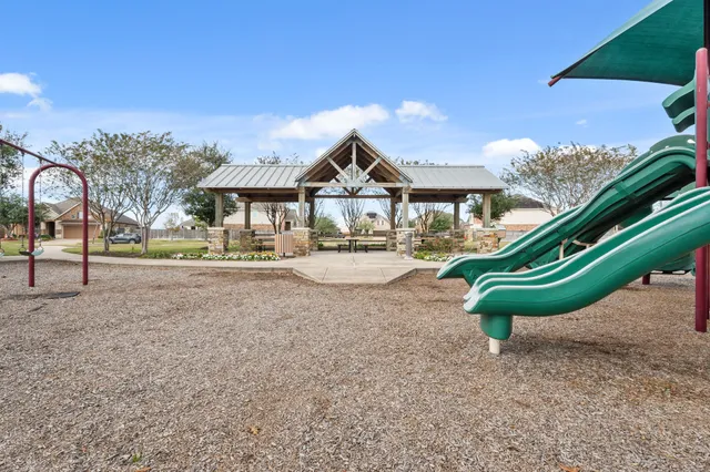 a view of a house with a yard and a garden