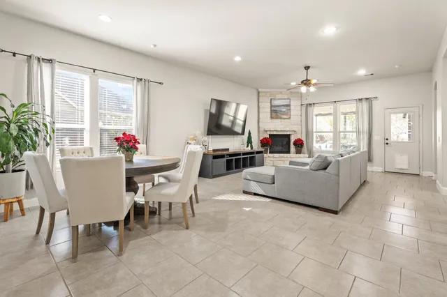 a living room with fireplace furniture and a large window