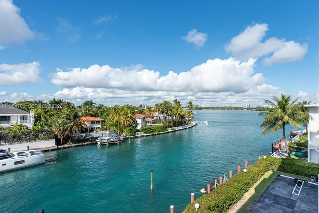 a view of a lake with lawn chairs