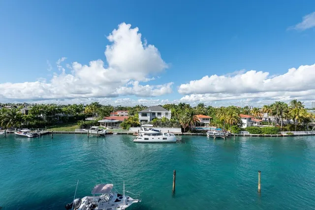 a view of a lake with lawn chairs
