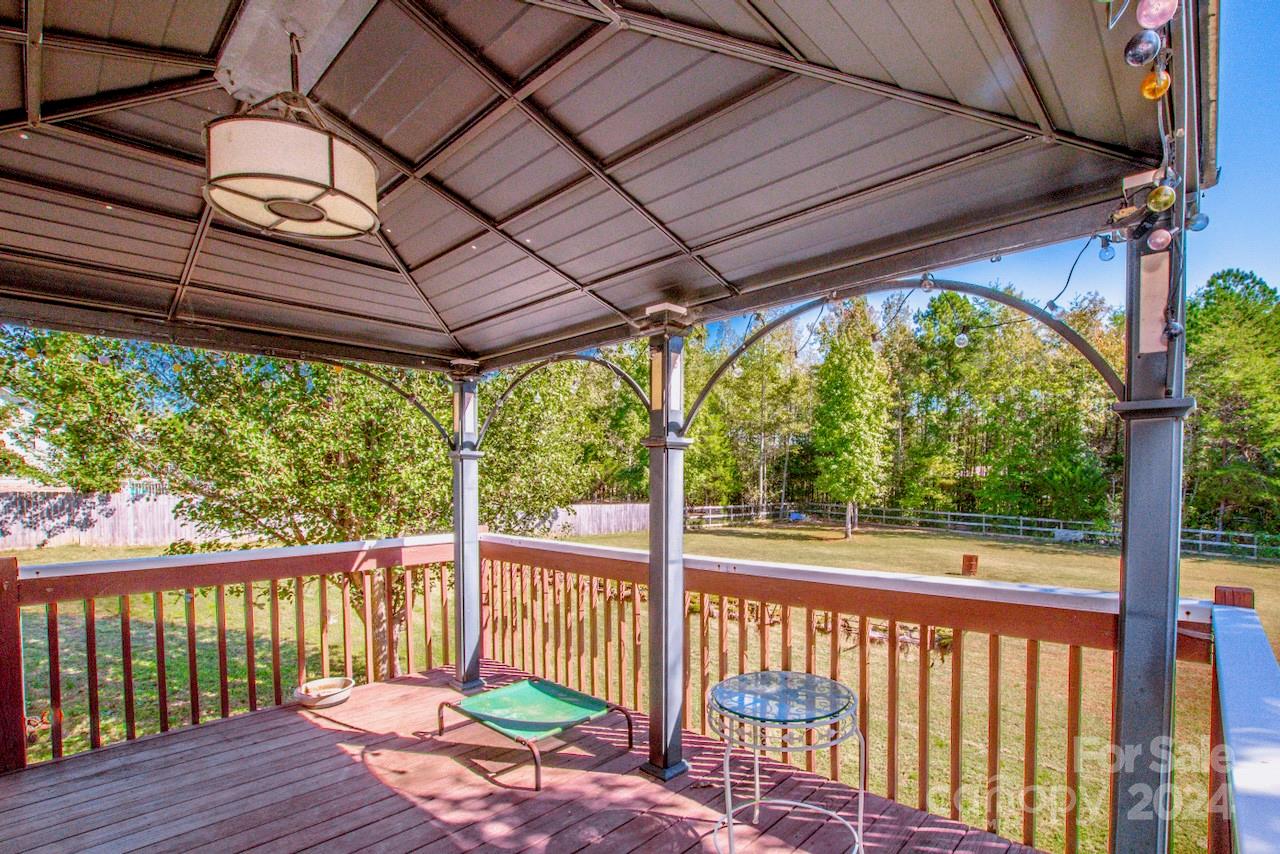 3510 Mack Ballard Road Maiden, NC 28650 - Photo 13 of 26 a view of a wooden deck next to a yard
