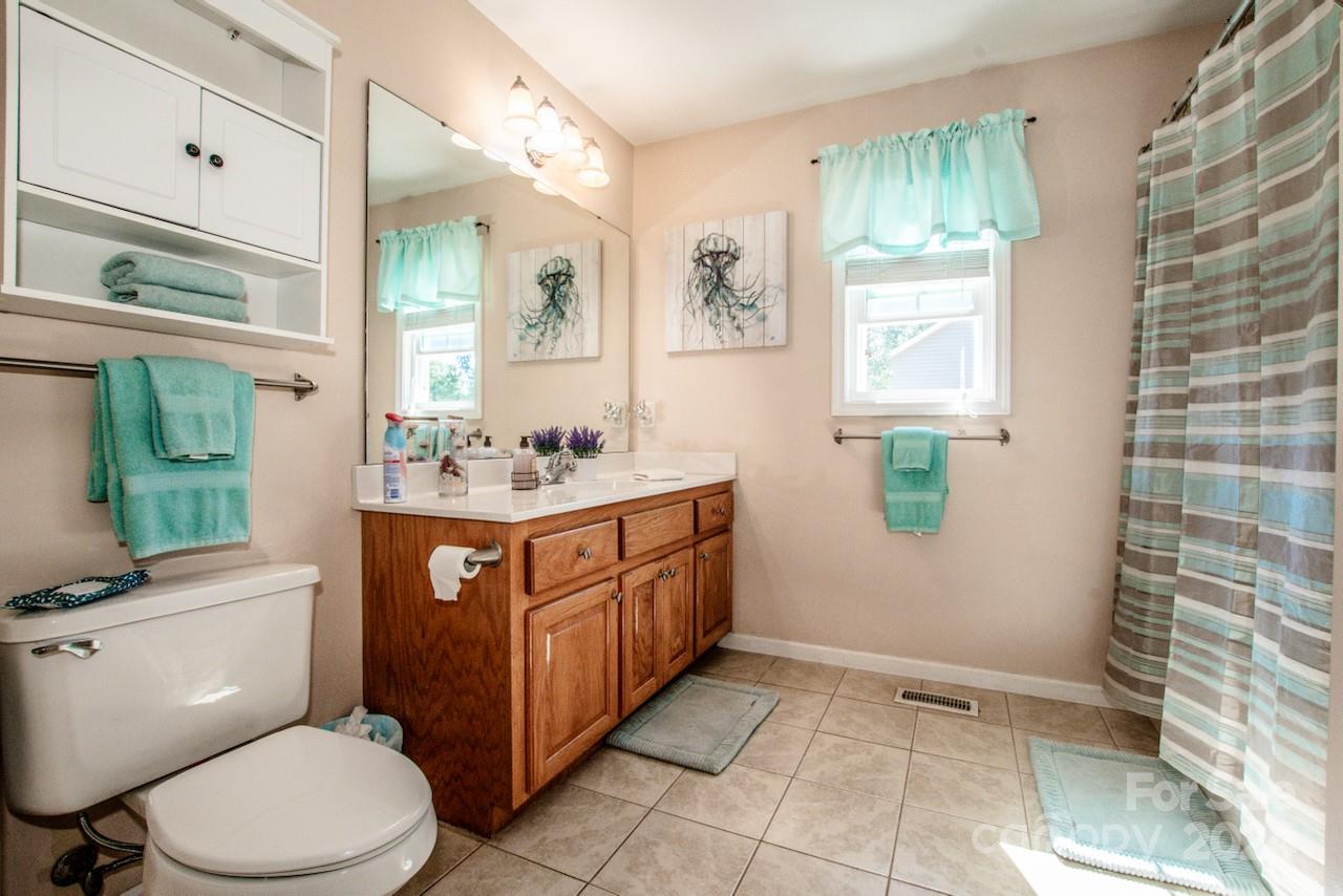 3510 Mack Ballard Road Maiden, NC 28650 - Photo 20 of 26 a bathroom with a sink a toilet and mirror