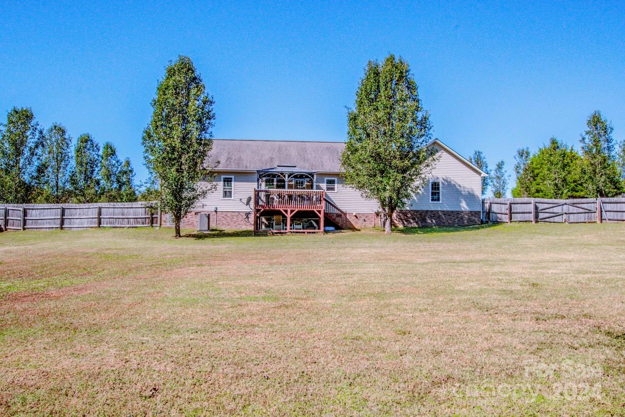 3510 Mack Ballard Road Maiden, NC 28650 - Photo 23 of 26 a tall yellow house with trees in front of it
