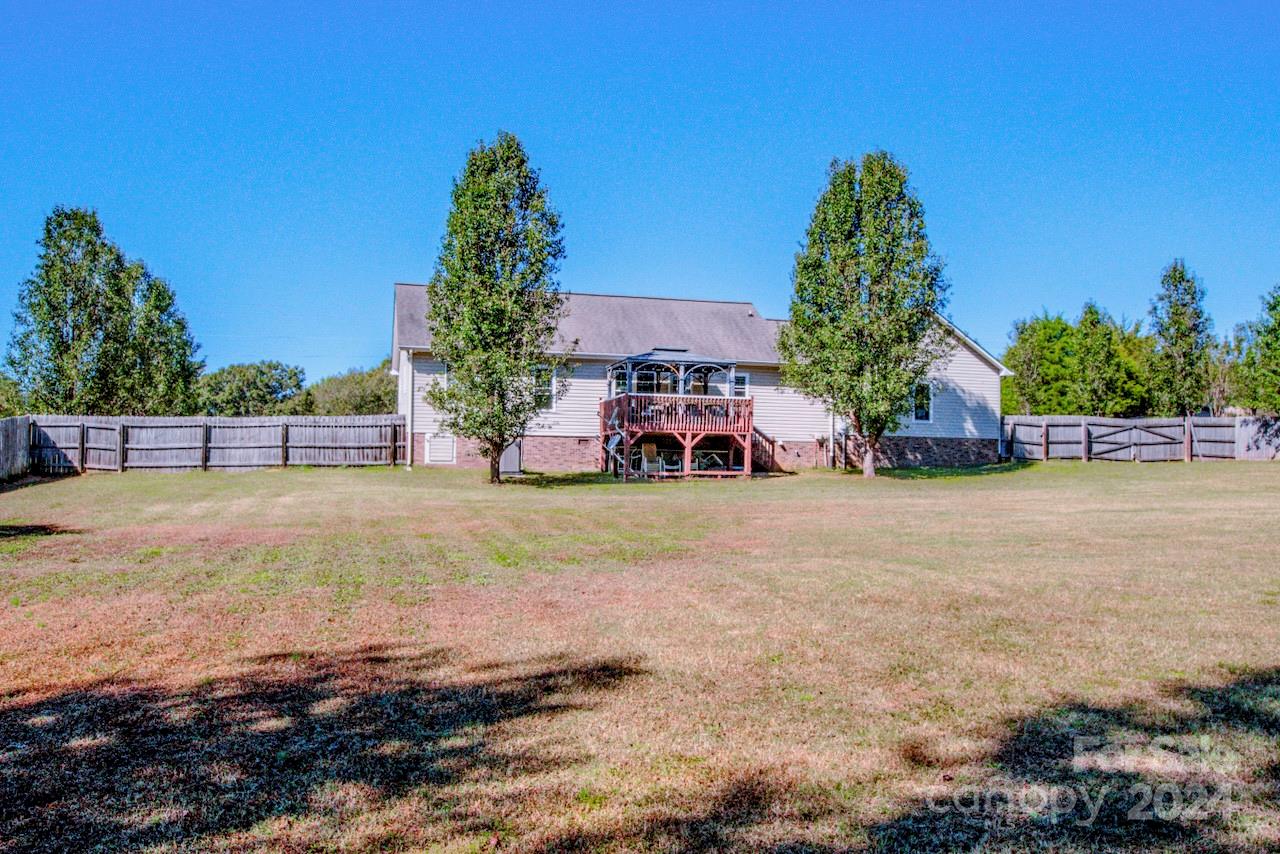 3510 Mack Ballard Road Maiden, NC 28650 - Photo 24 of 26 a yellow house with trees in front of it