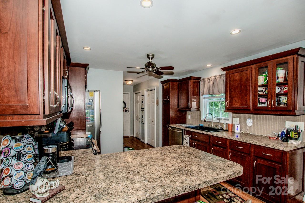 3510 Mack Ballard Road Maiden, NC 28650 - Photo 8 of 26 a kitchen with stainless steel appliances granite countertop a sink stove and refrigerator