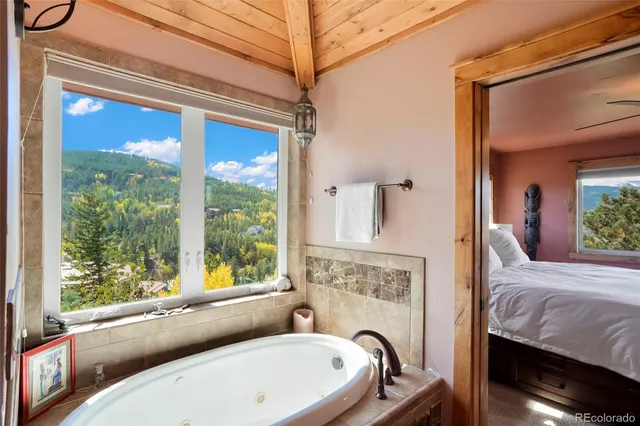 a spacious bathroom with a double vanity sink a mirror and a shower