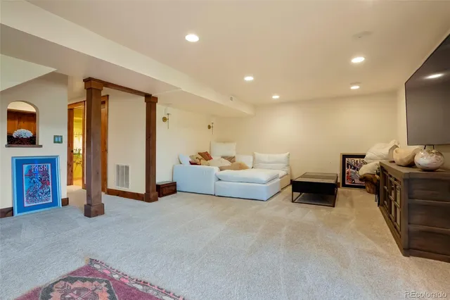 a view of a livingroom with workspace and a window