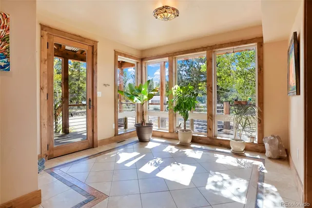 a view of a balcony with wooden floor and outdoor seating