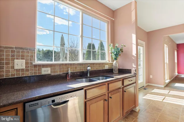 a kitchen with granite countertop a sink and a window
