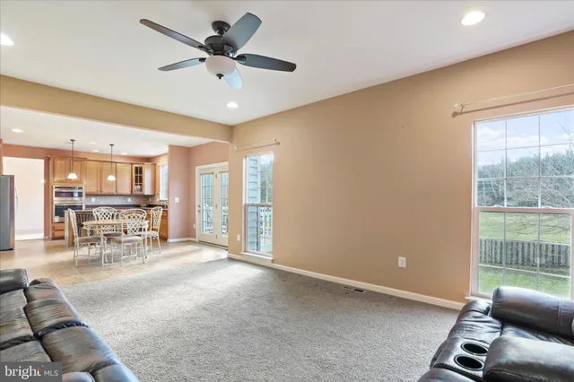a view of a livingroom with furniture and a ceiling fan