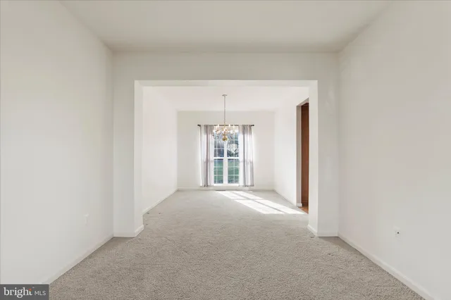an empty room with windows and cabinet