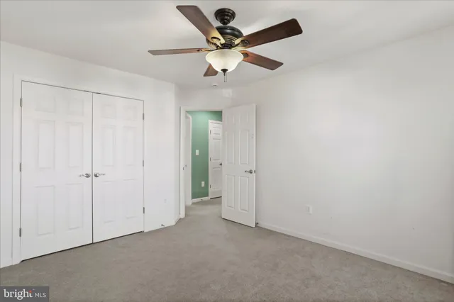 a bathroom with a granite countertop sink a toilet and a large mirror