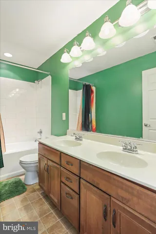 a bedroom with a bed and large windows