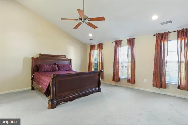 a bathroom with a tub a sink and a window