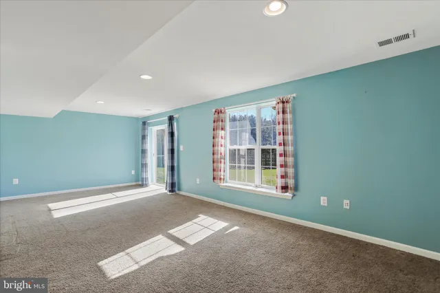 a view of a house with backyard and a tree