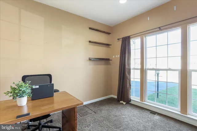 a workspace with furniture and window