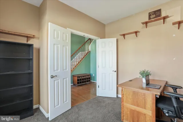 a view of an entryway with workspace and bedroom