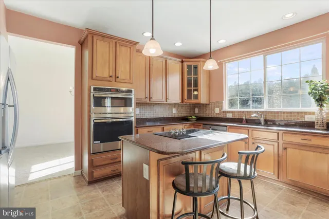 a kitchen with a stove a sink and a refrigerator