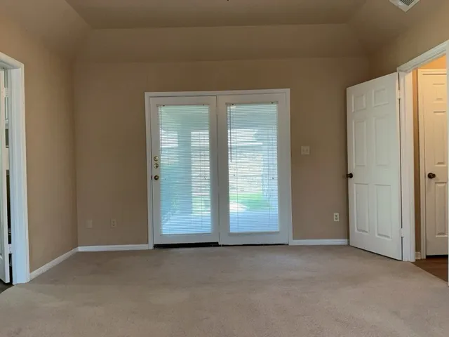 a spacious bathroom with a double vanity sink and a mirror