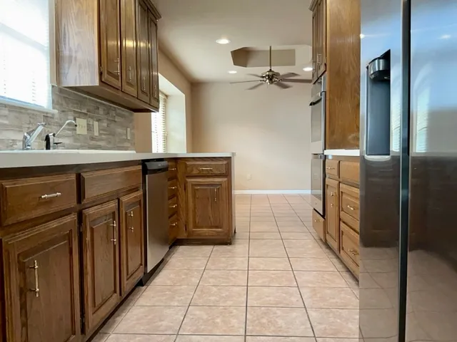 a kitchen with stainless steel appliances granite countertop a stove microwave and cabinets