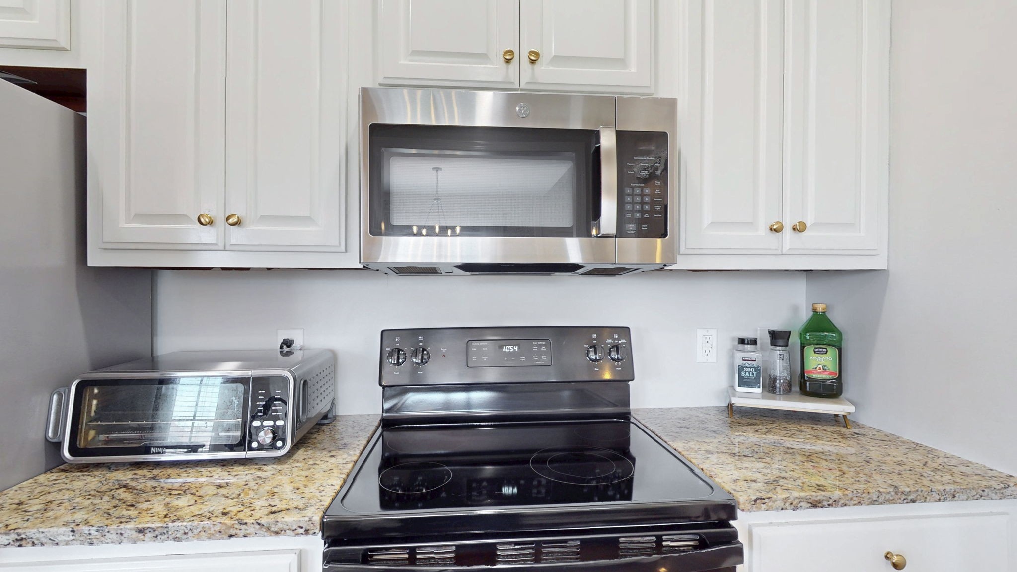 864 Bradshaw Road Lebanon, TN 37087 - Photo 13 of 41 a kitchen with stainless steel appliances granite countertop a stove and a microwave