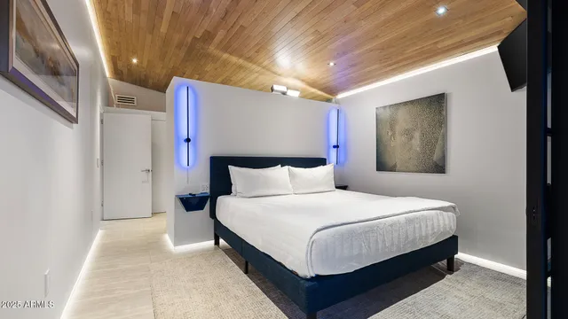 a bedroom with a bed and a mirror