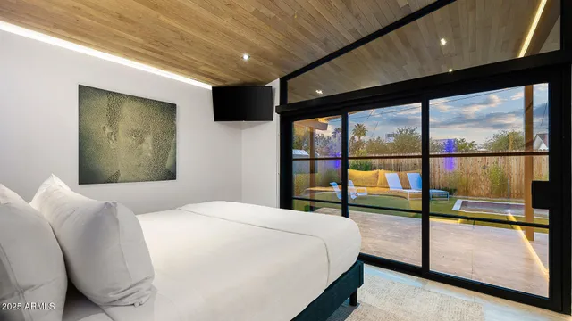 a bedroom with a large bed and a large window