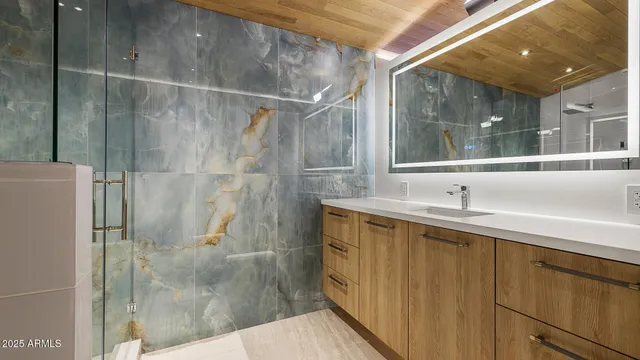 a bathroom with a sink and mirror