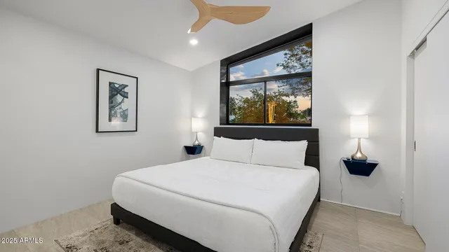 a bedroom with a large bed and a window