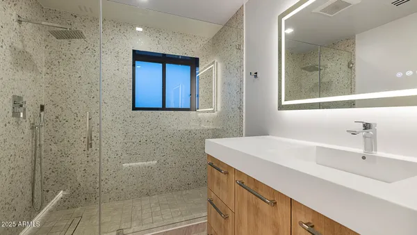 a bathroom with a sink a vanity and a mirror